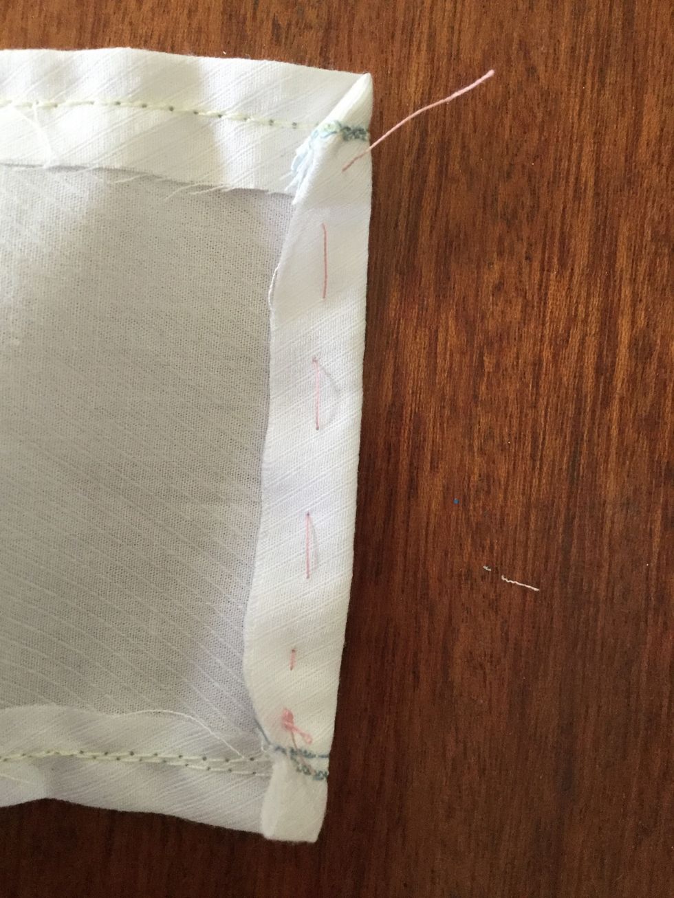 Tack the edge you have just sewn and fold down. Do this on both pieces of material. (Use a needle and thread, not the sewing machine.)