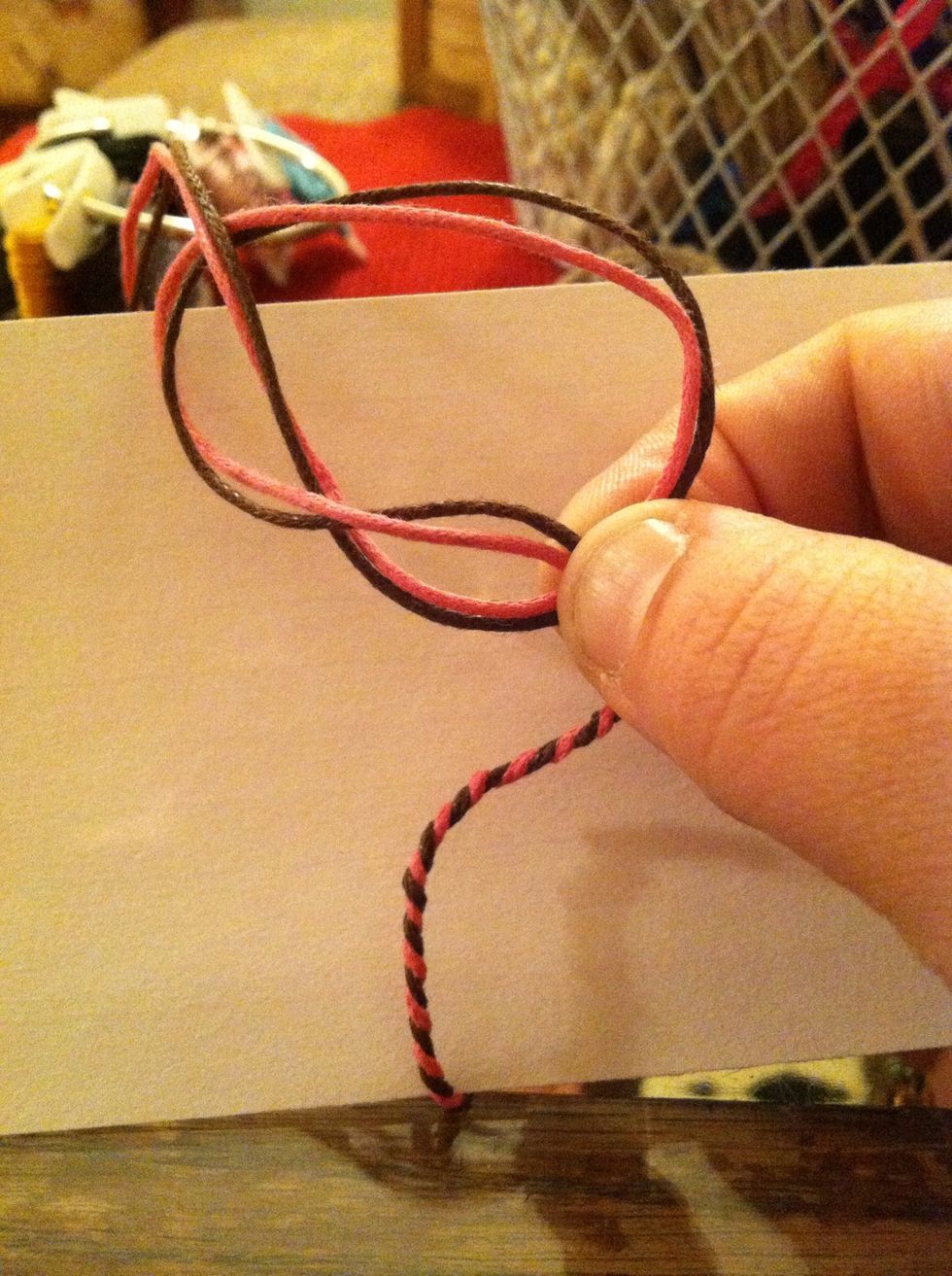 Tail end through the loop while still pinching tightly. Then SLOWLY! Pull it through pushing the closing knot towards your fingers. Patience is key.