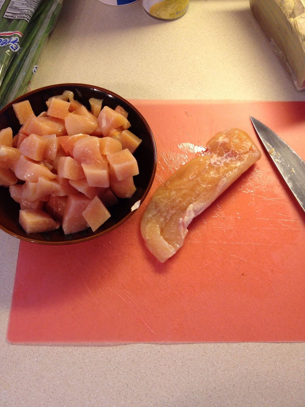 Take 1 1/2 pounds of boneless skinless chicken breasts and cut in bite size pieces. My chicken was still slightly frozen making it easier to cut up!