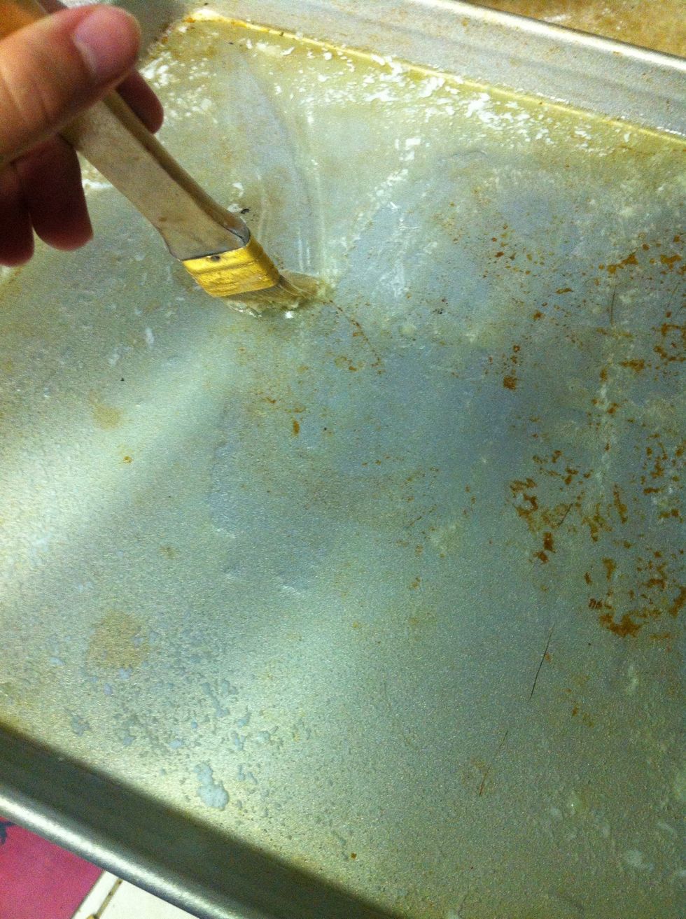 Take 1/2 a stick of butter and melt it on the Pan in the preheated oven. Once melted, spread across the whole pan.