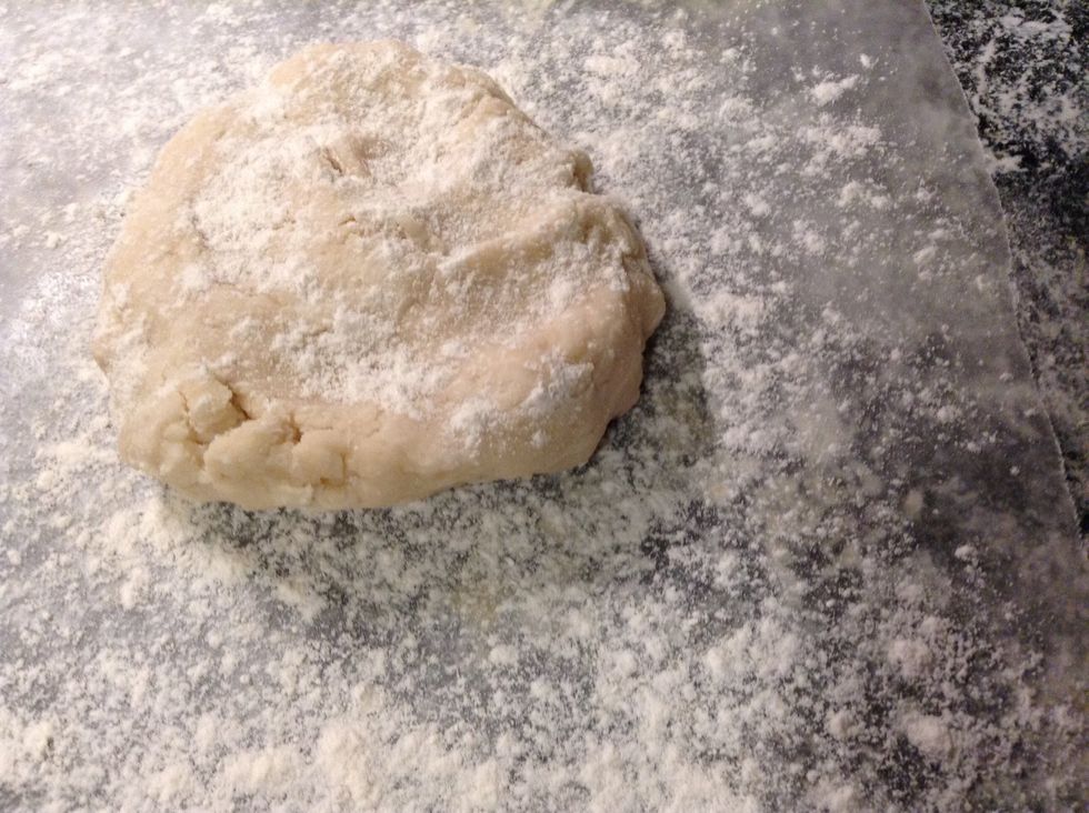Take 1/2 of the dough and sprinkle with flour on wax paper.