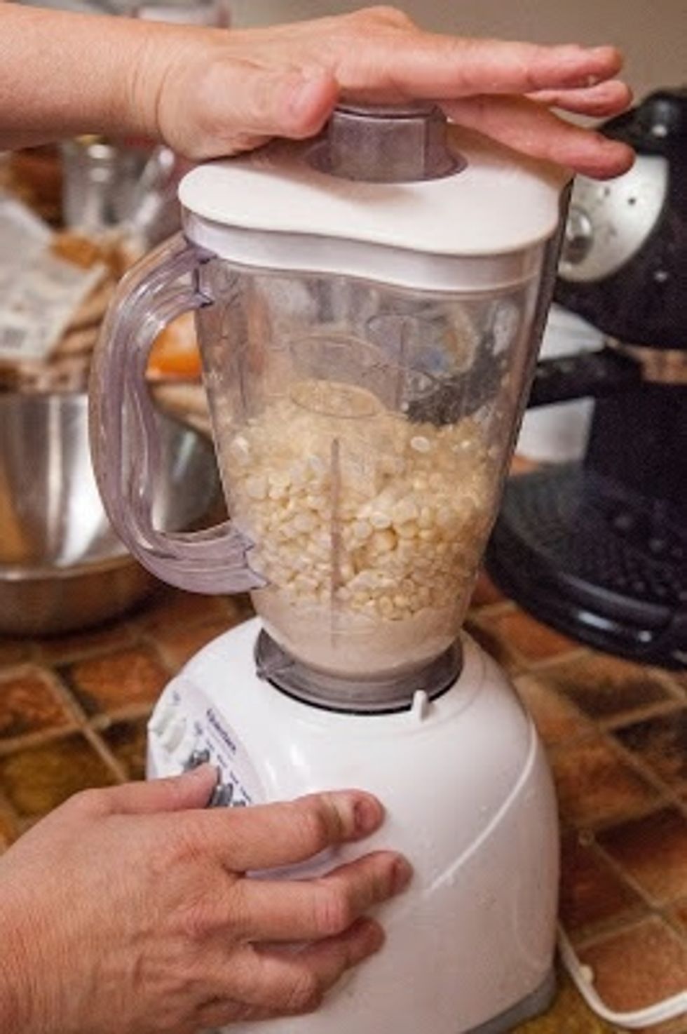Take 1/2 of the kernels and grind them up in a blender. Do Not add any water. Grind them up until they form a smooth batter.