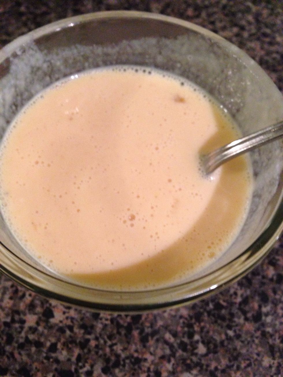 Take 1/4 cup of sauce and slowly pour into beaten egg. Whisking constantly to avoid cooking the egg. Whisk until smooth.