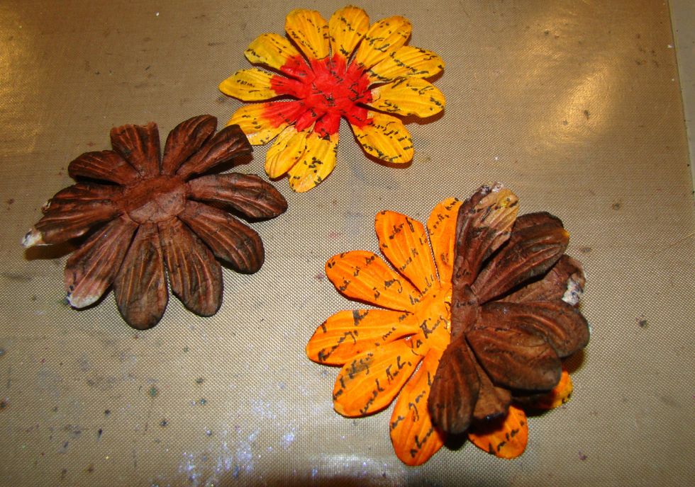 Take 1 brown flower and fold in half and glue, take the other brown flower and fold in half and glue to the other side. Glue your last flower to the top and fluff all the petals.