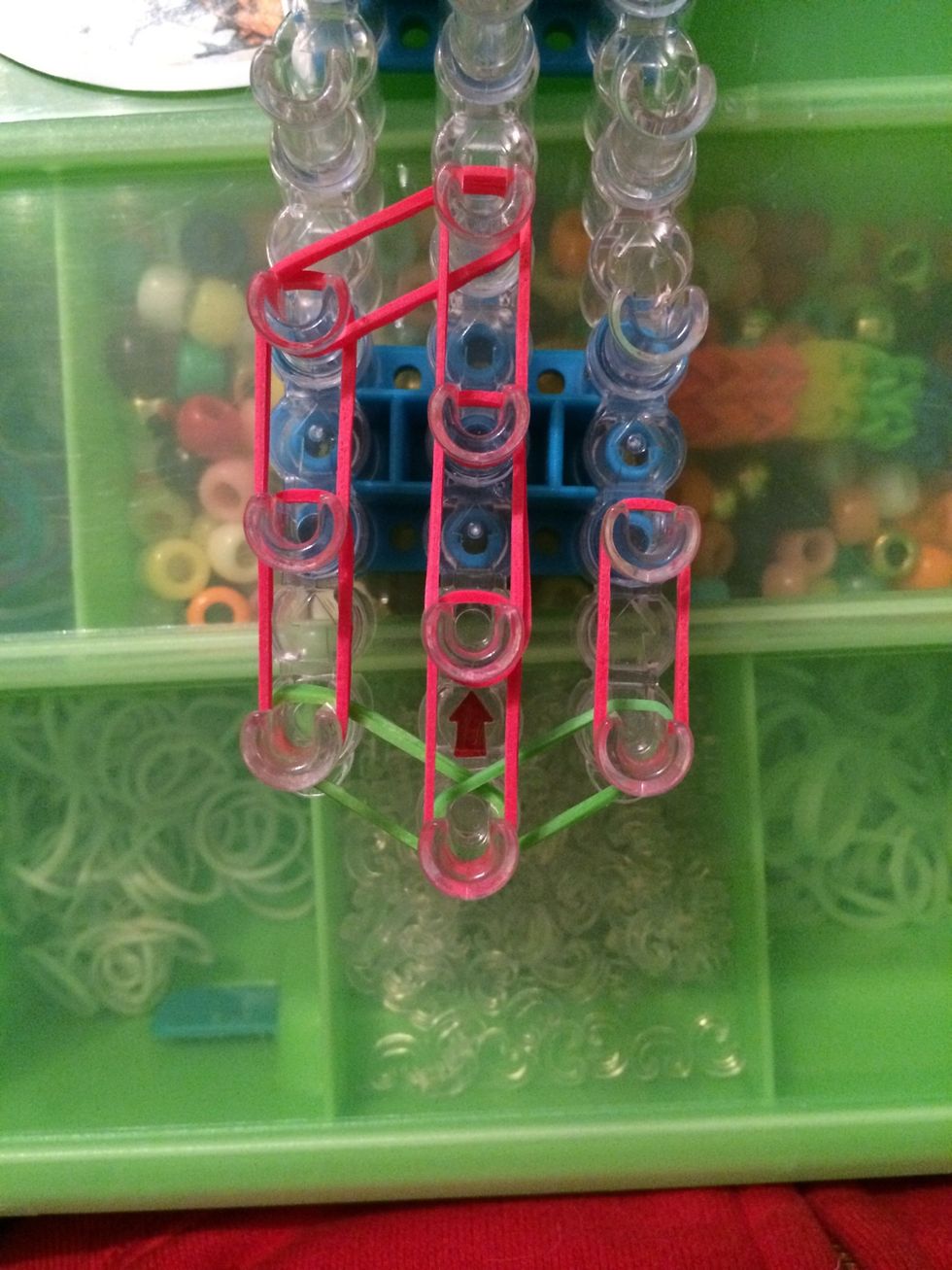 Take 2 more red bands and place them on the first and second pegs on the ride side.