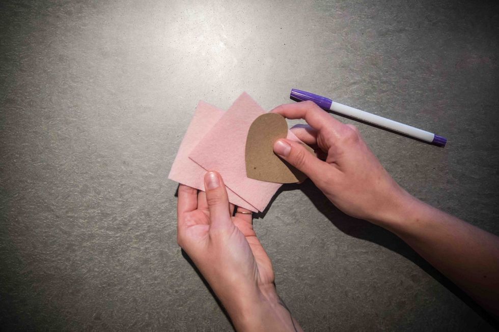 Take 2 sheets of a single color and place one on top of the other with the heart template on top.