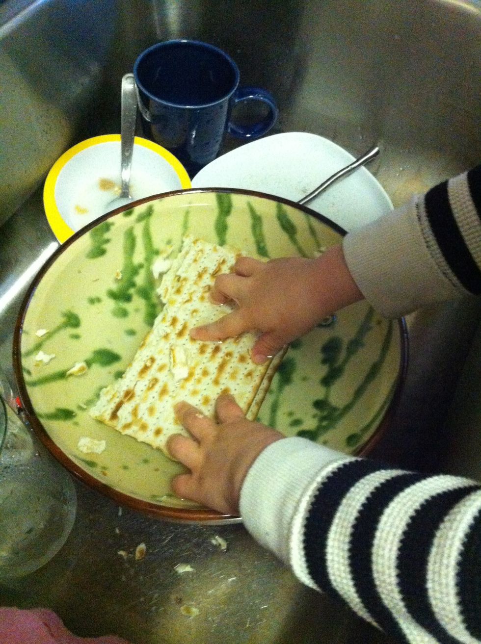 Take 3 matzahs at the time, break into half, and dip in warm water. Wriggle and flip. Oh, did I mention you should let your 3.5yo do this?