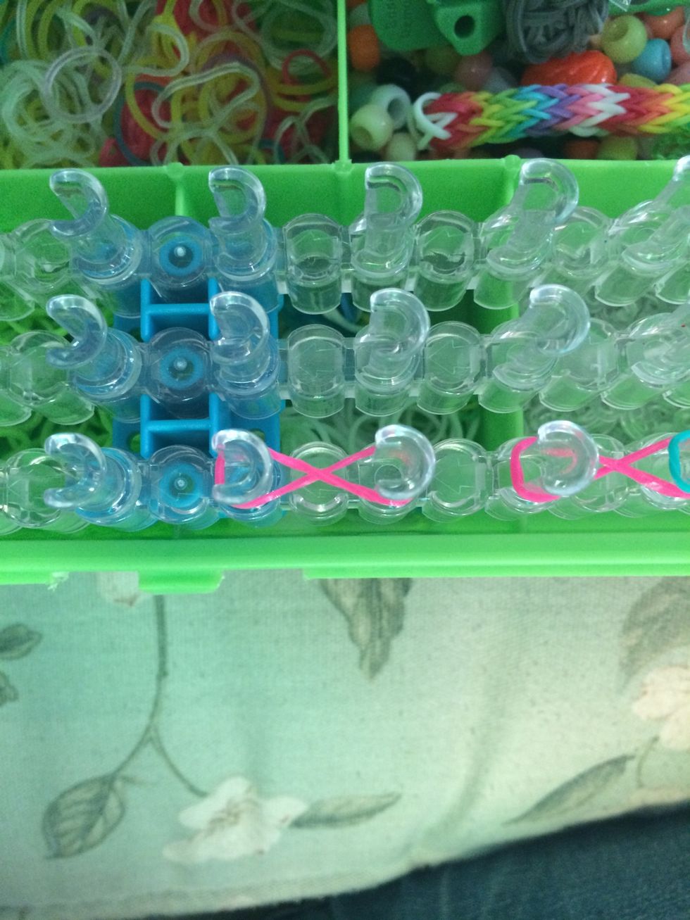 Take 4 bands and make figure rights on 4 sets of pegs