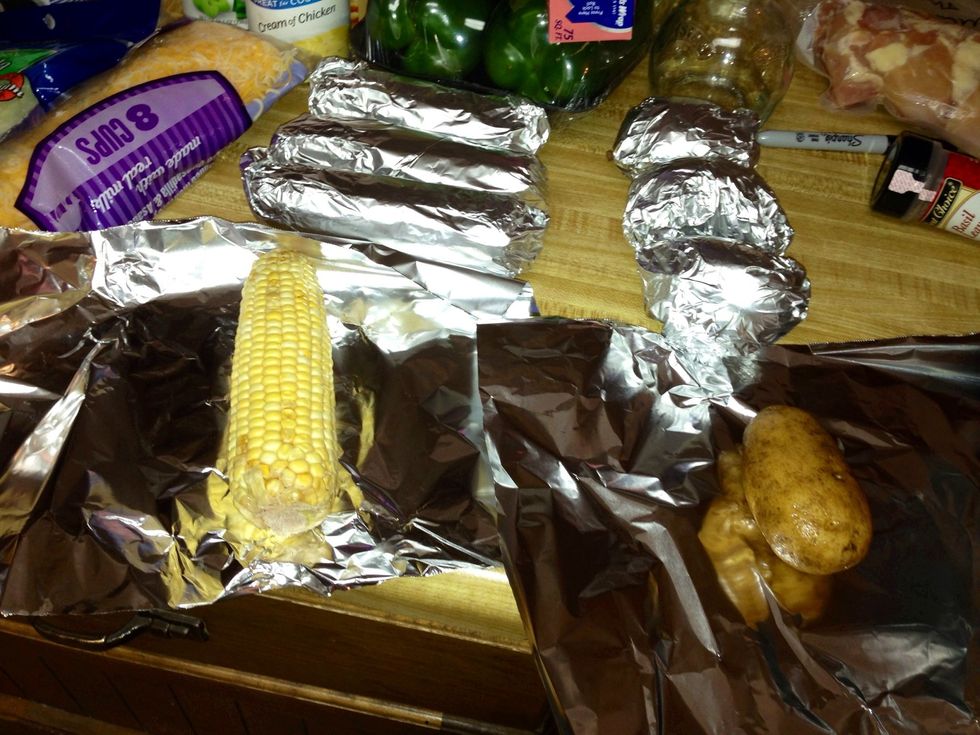 Take 4 corn on the cobs and 4 washed potatoes and wrap each in foil.