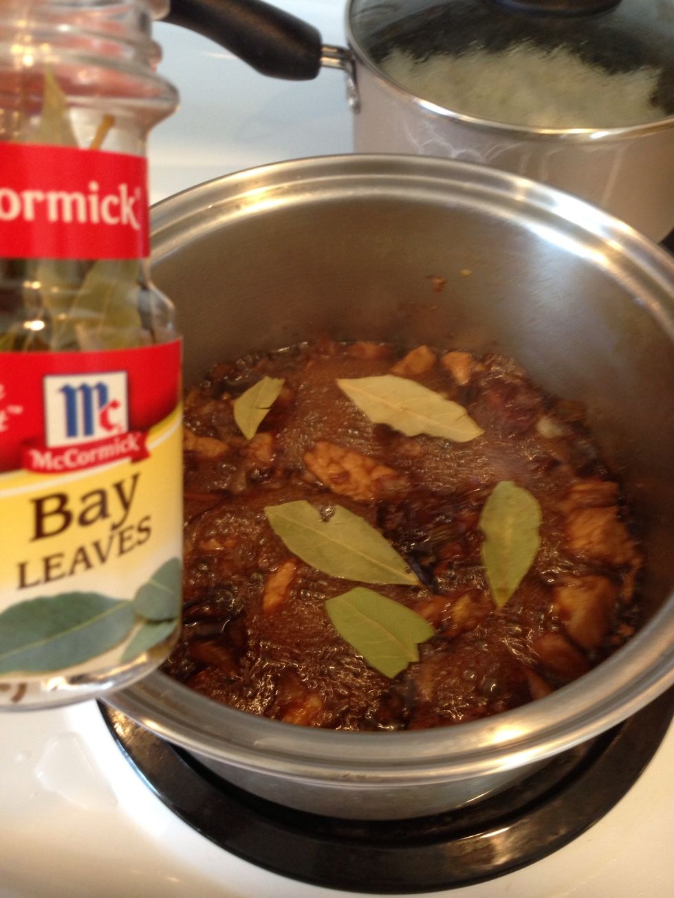 Take 5 or six bay leaves and spread on top of the pork, do not stir. I added about 2 more tablespoons of brown sugar because I like it sweeter. Sprinkle it in.