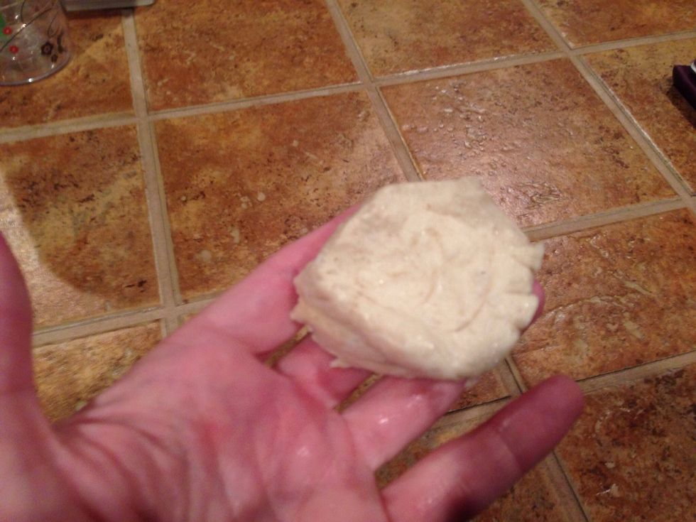 Take a biscuit out of the can and punch a small hole in the middle.