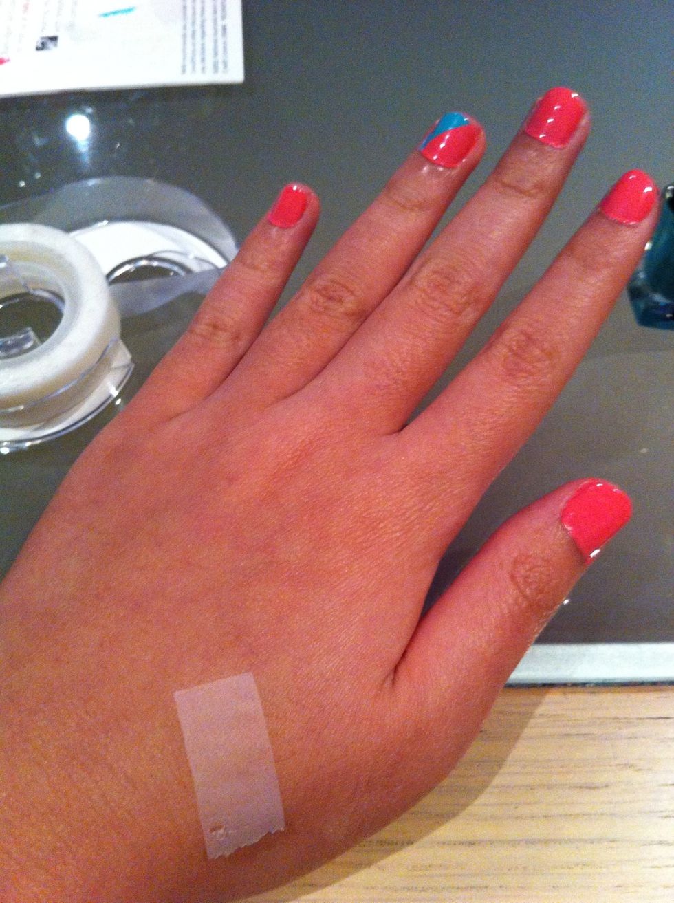 Take a bit of the scotch tape and blot some of the glue off on your hand
