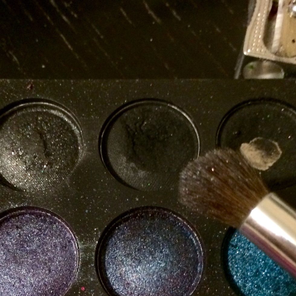 Take a black eyeshadow on a fluffy brush...