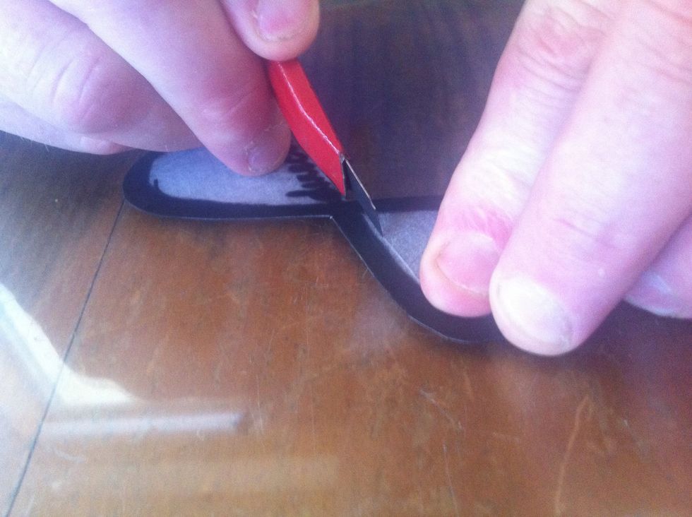 Take a carving/ pocket knife and cut the inside of the shape out. WARNING: Be careful! You don't want to cut yourself or make a mistake! The plastic snaps quite easily!