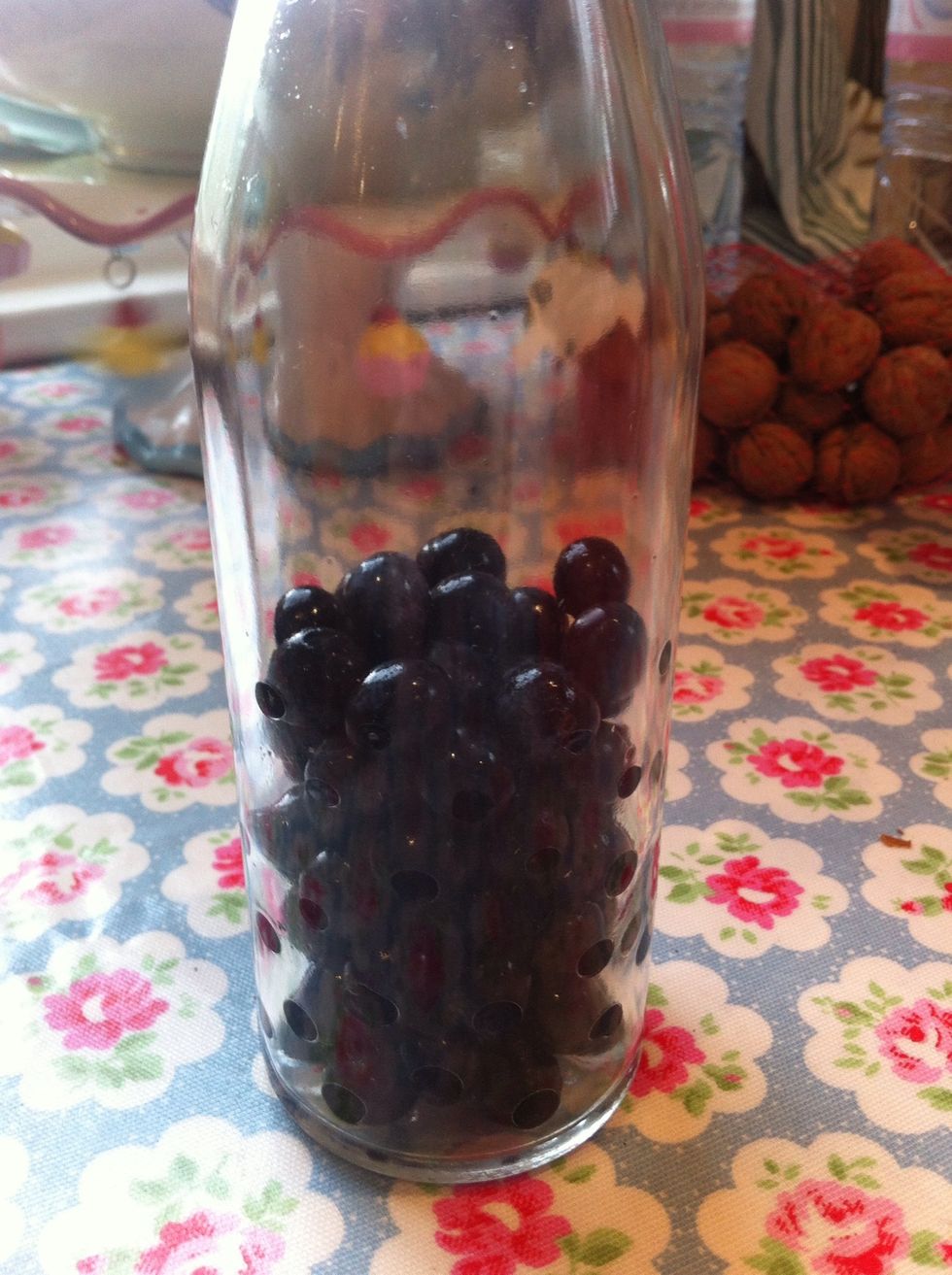 Take a clean bottle - any bottle will do - and fill to about half with sloes. This isn't an exact science so don't worry if there are too many or too few.