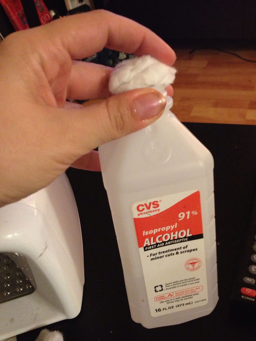 Take a clean cotton ball and soak it in alcohol.