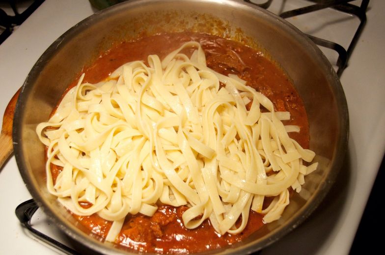 https://guides.brit.co/media-library/take-a-couple-ladles-full-of-the-meat-sauce-and-add-it-to-a-large-saut-u00e9-pan-add-the-pasta-and-gently-toss-them-to-mix-t.jpg?id=24126772&width=784&quality=85