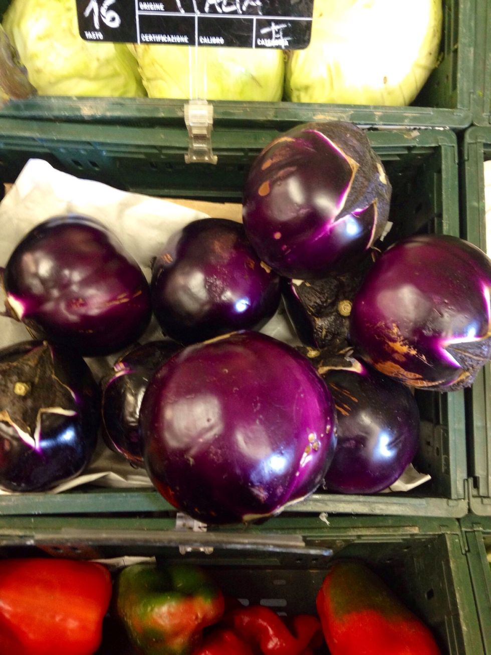 Take a couple of big round violet aubergines, peel them and cut into slices of half an inch