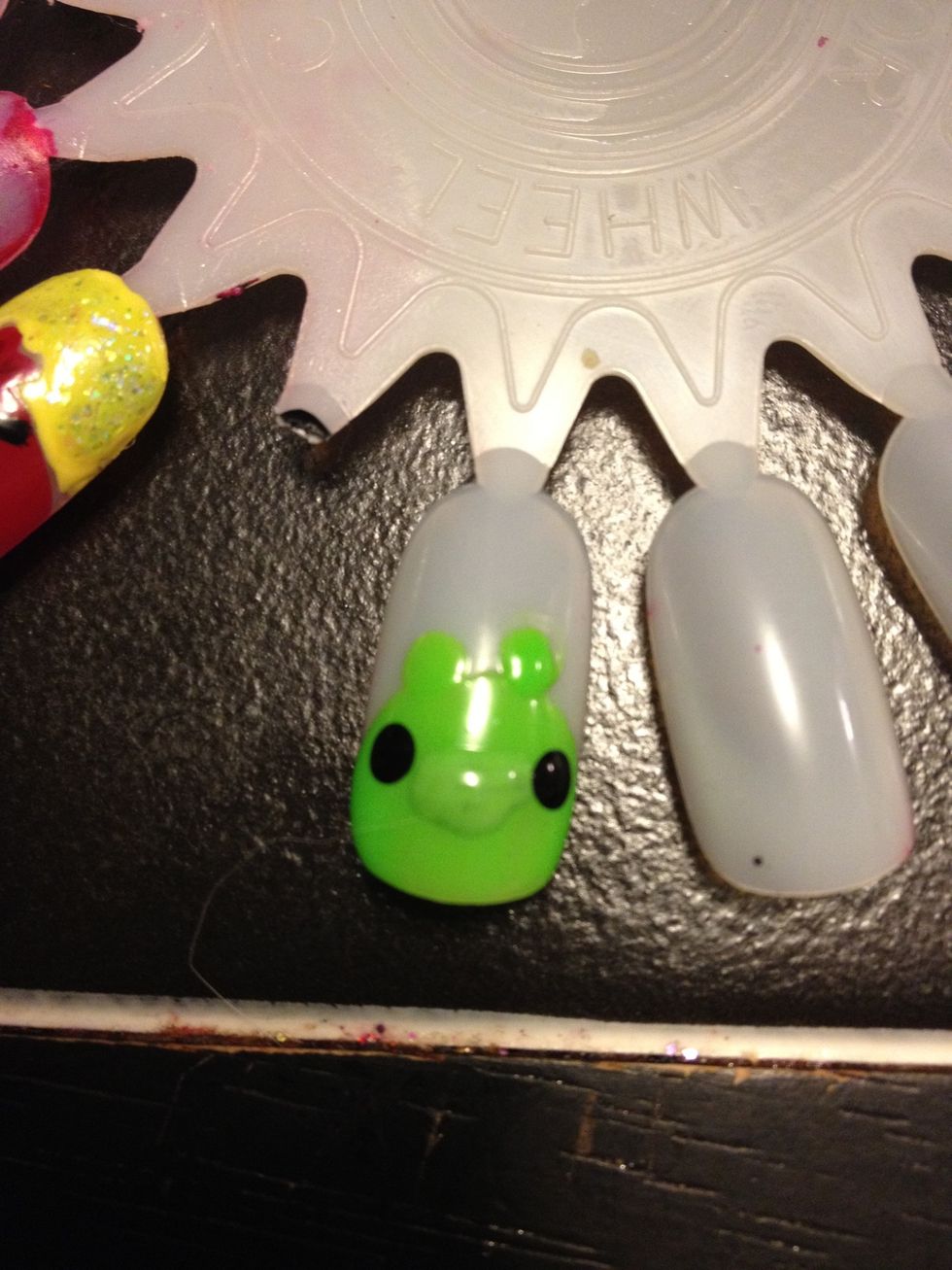 Take a dotting tool and make two eyes on the sides of the nose.