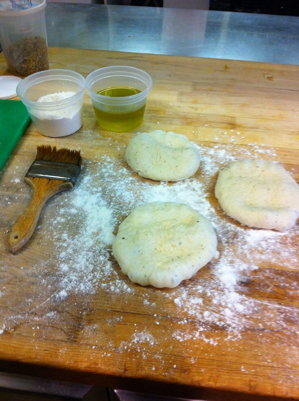 Take a few out at a time and squish them by hand to get out excess gasses and prep the gluten for rolling.