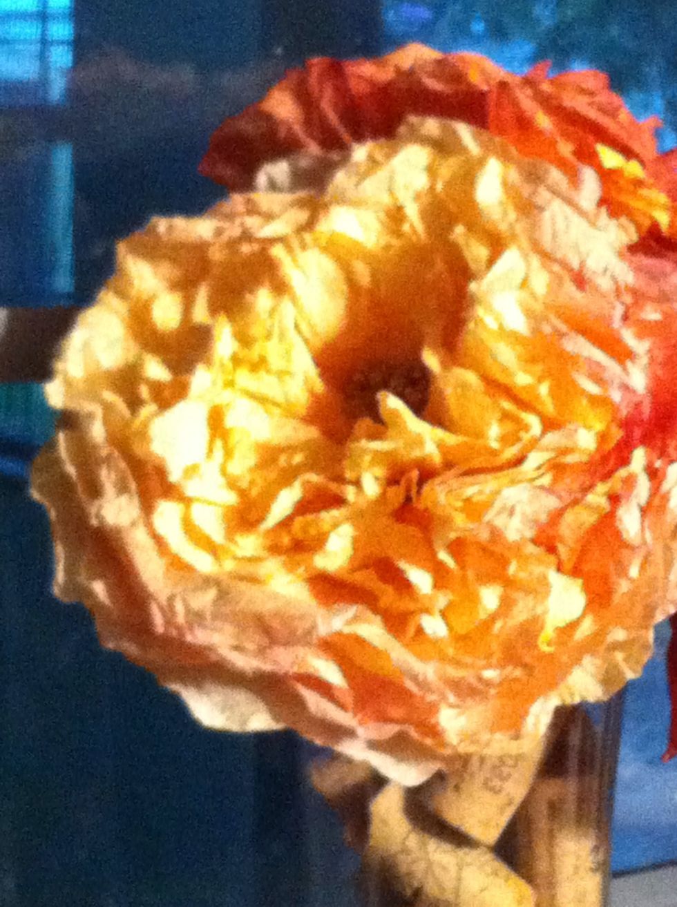 Take a flower and push the stem up through the center of the flower. Put the plastic center back on the stem.