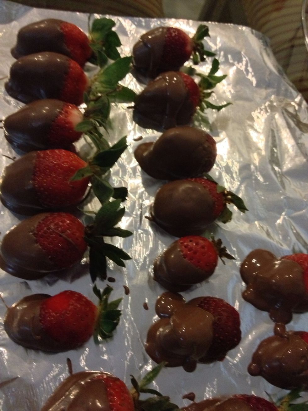 Take a foil paper rectangle and place on the plank. Dip strawberries in chocolate and place them on the foil. I poured extra chocolate over strawberries. You can even coat it twice for a thicker coat