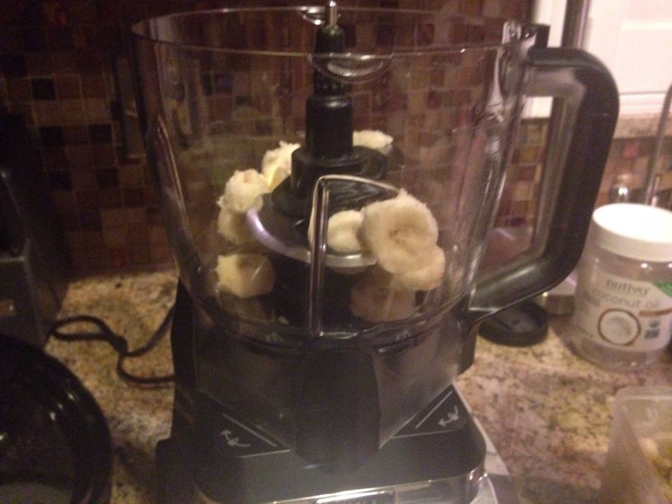 Take a fork and break up some sliced bananas to put in the blender