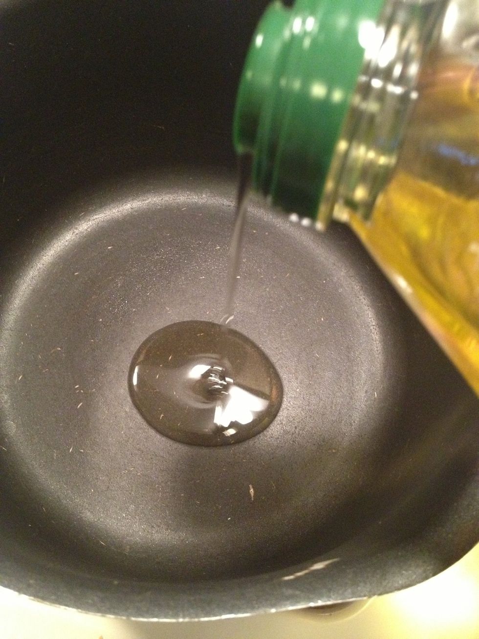 Take a heavy sauce pan and put it over medium heat. Add the oil