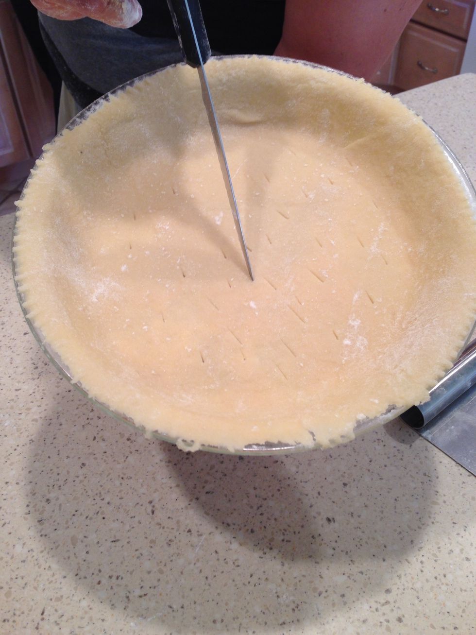 Take a knife and tap the bottom of the crust. This prevents it from being gooey when it cooks!