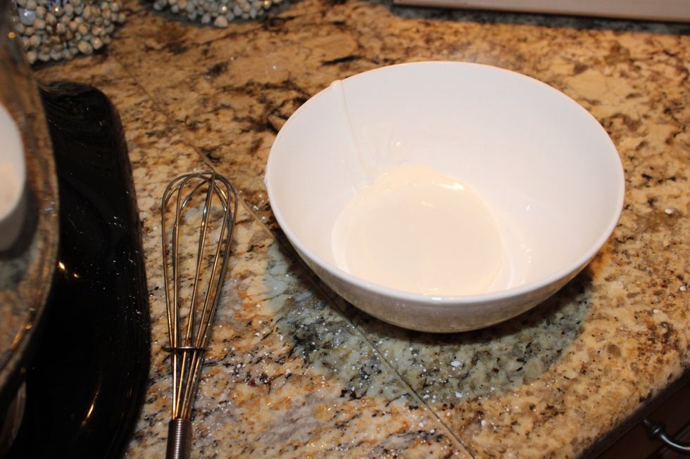 Take a little bit of icing out of the mixing bowl and put it into a separate bowl