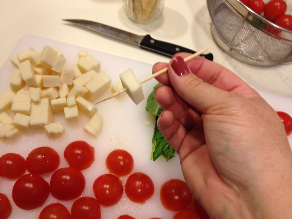 Take a long toothpick and slide on a cube of mozzarella.