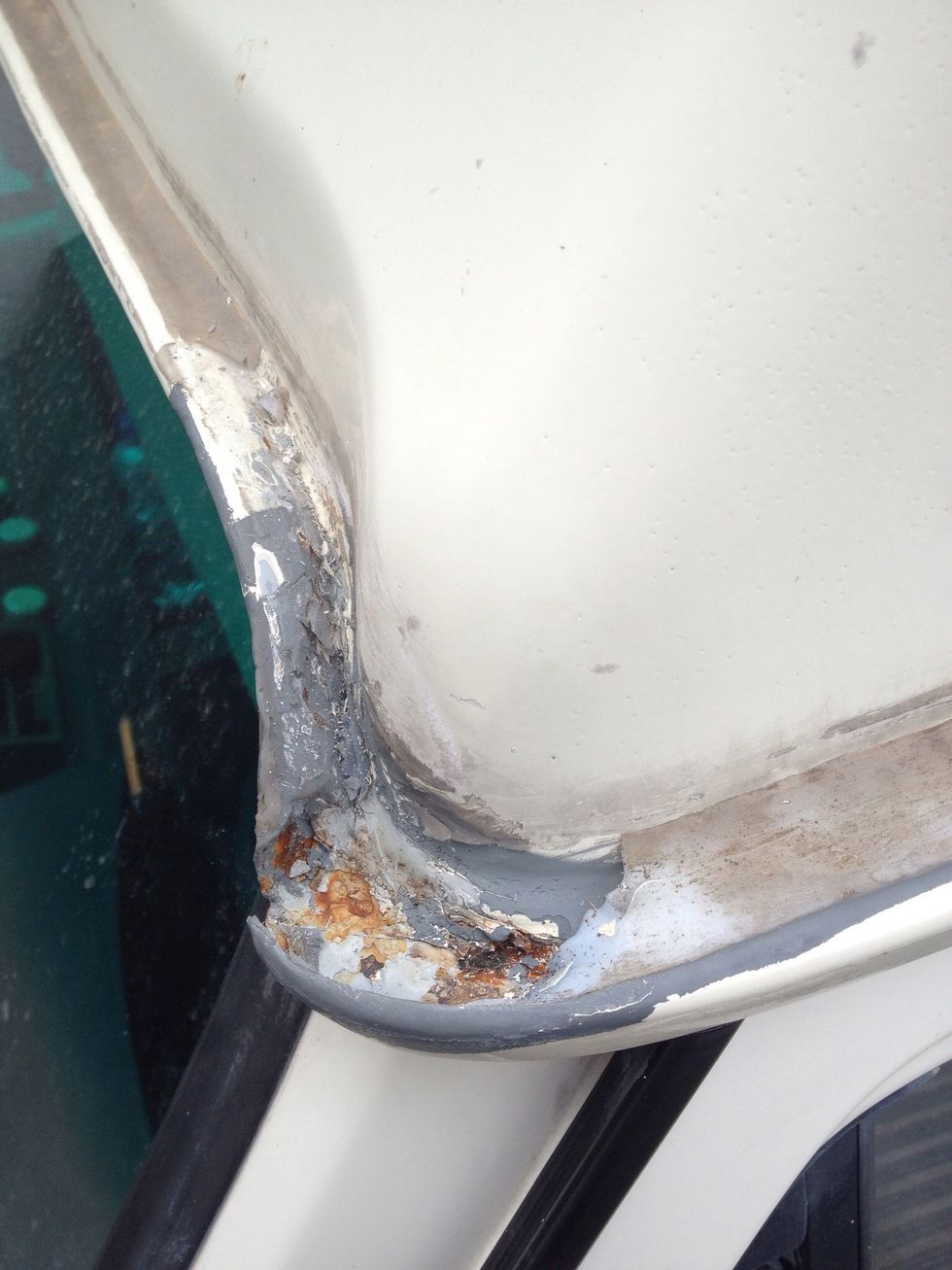 Take a look at the drip rail of your van. If you haven't owned it for the past 10 years, chances are that it is filled with silicone to cover rust. Peel it off and look below.