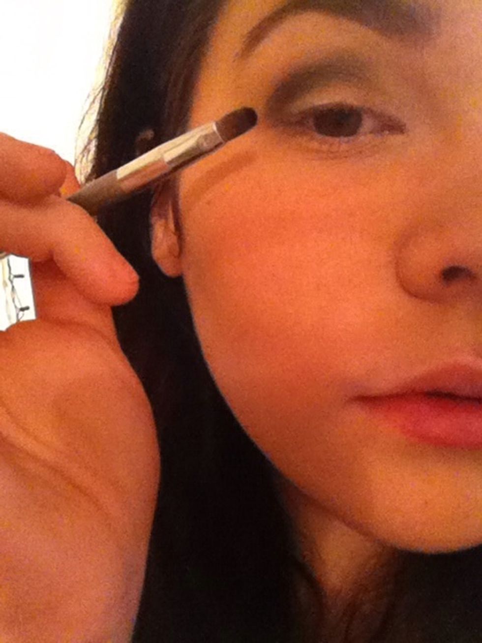 Take a matte black on a thin brush and apply only in the crease and outer corner, blend in green by pulling the color diagonally towards your nose
