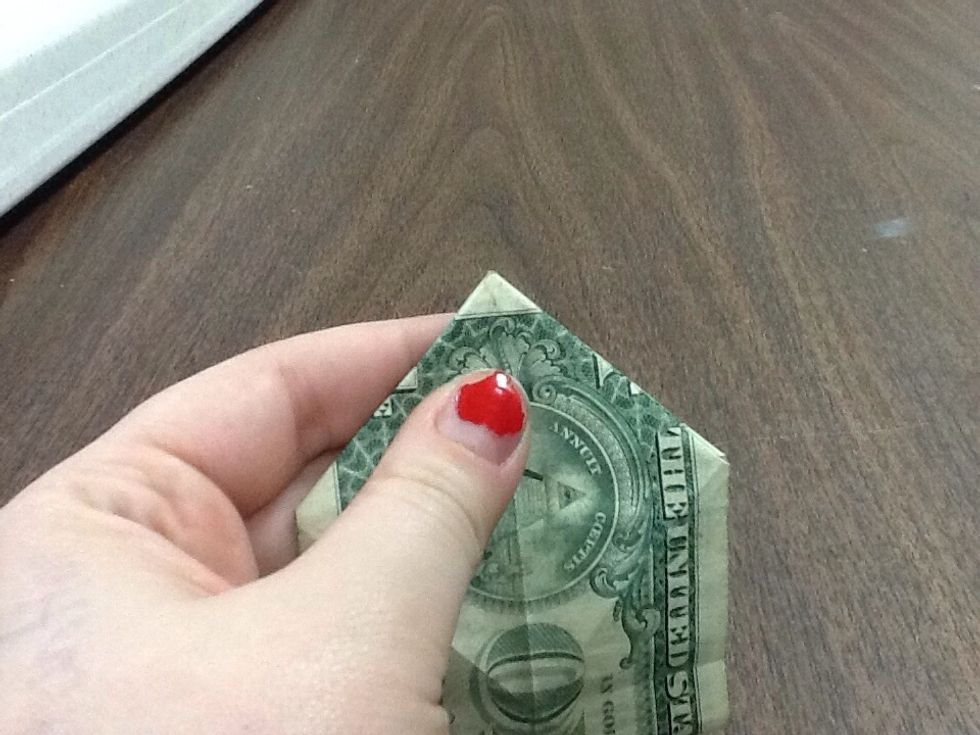 Take a moment to make sure that the fold is very precise, meeting the tips at exactly the right place. The future of this dollar depends on it. Don't let it down. Washington will be disappointed.