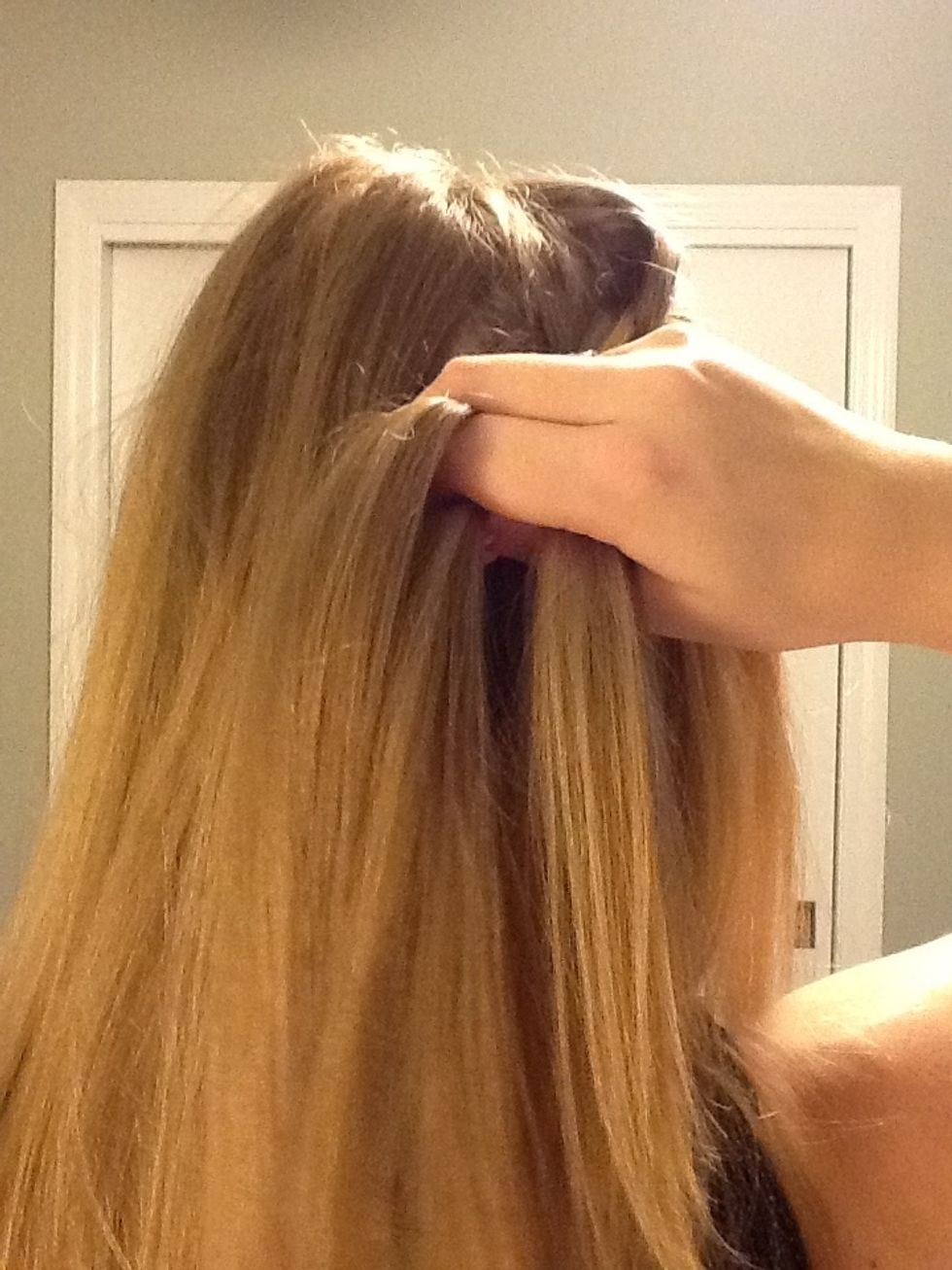 Take a new section of hair the same size as the one you dropped. This is the new right section of hair. Cross it over so it becomes the middle section.