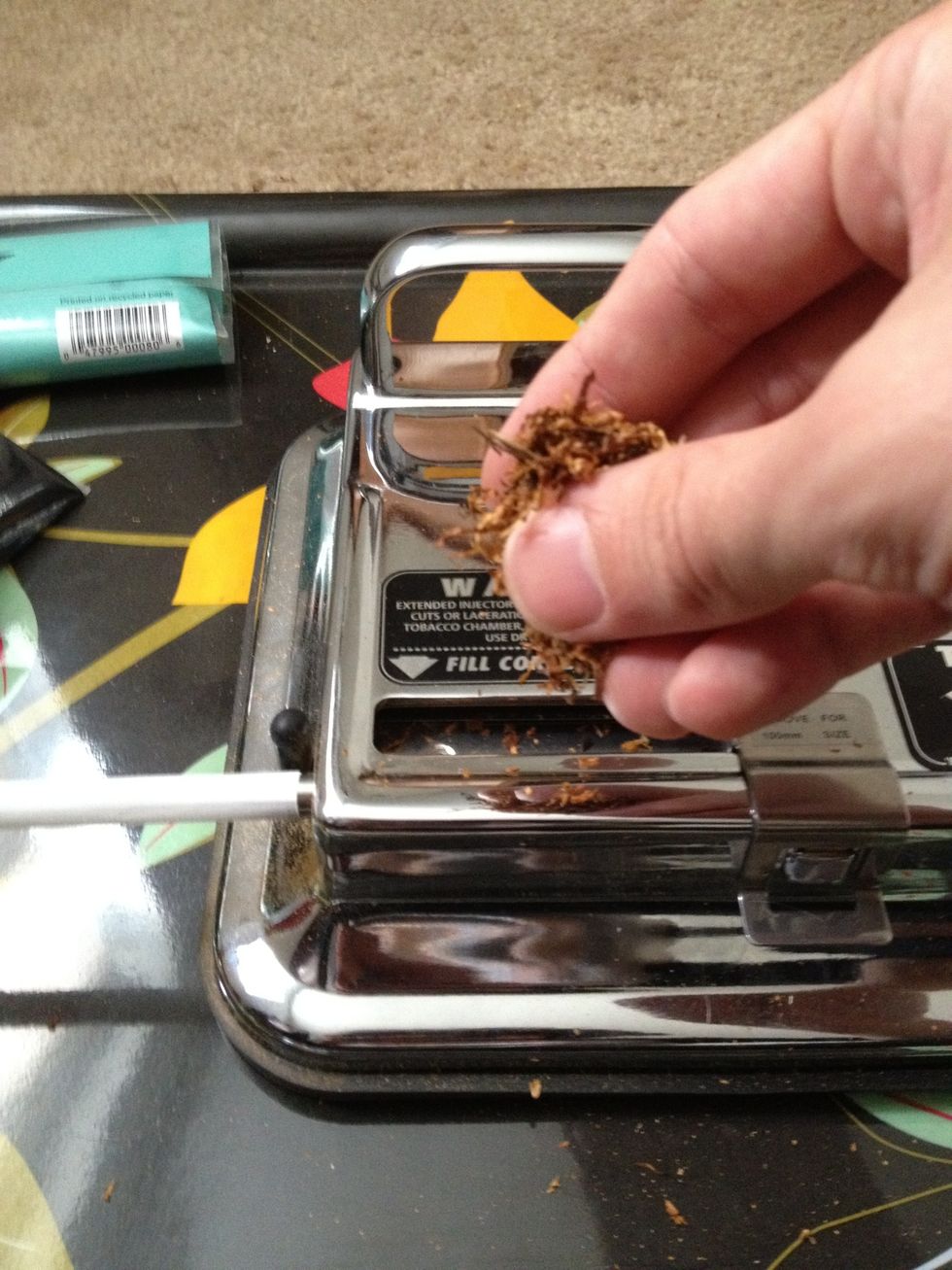 Take a obese pinch of tobacco and put it into the chamber. Don't put to much or to little unless you want to smoke a log/paper. Some people may like it differently so experiment around with this step.