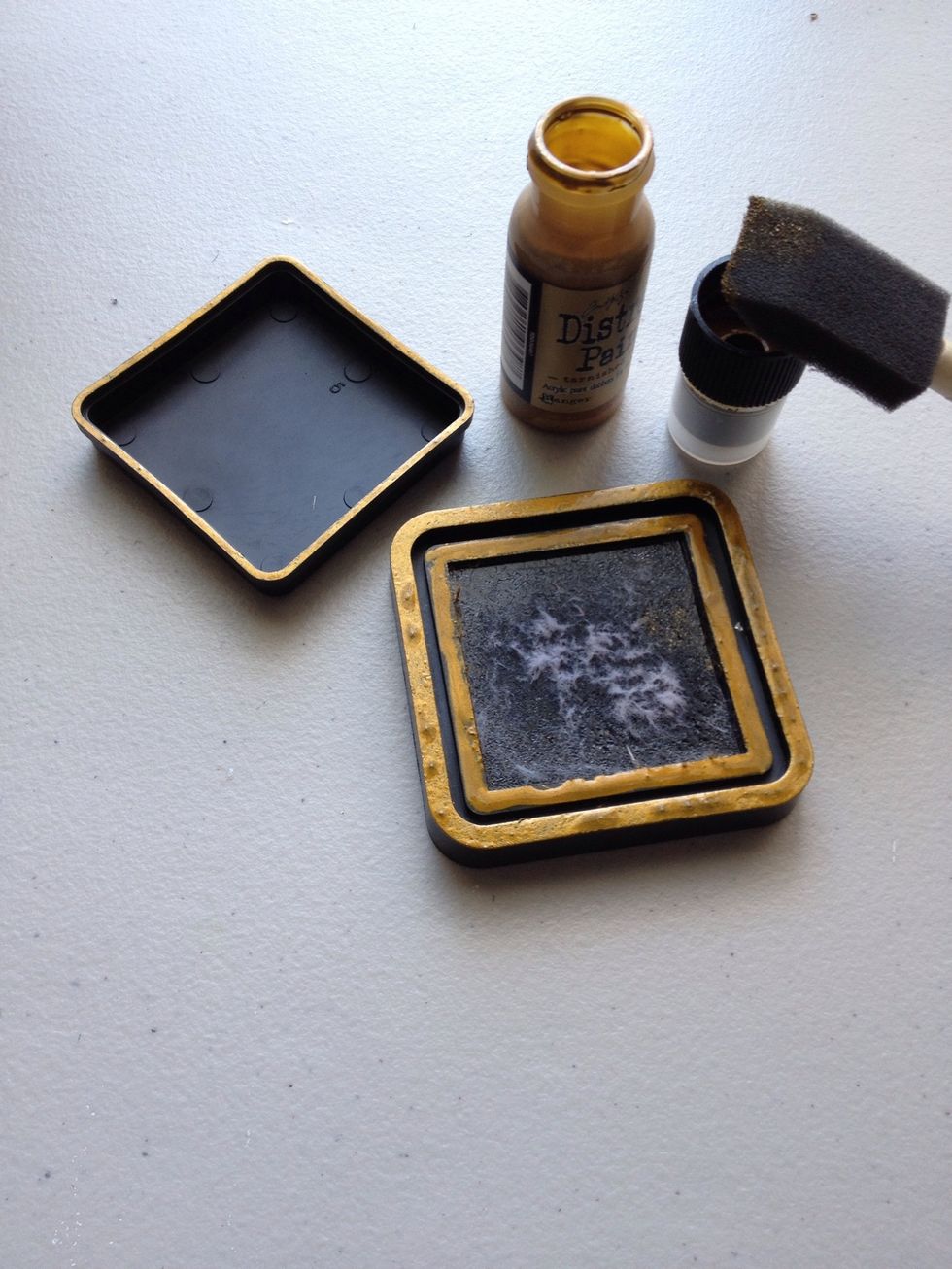 Take a paint brush and some Tim Holtz Distress Paint in Tarnished Brass and cover the ink pad edges as shown.