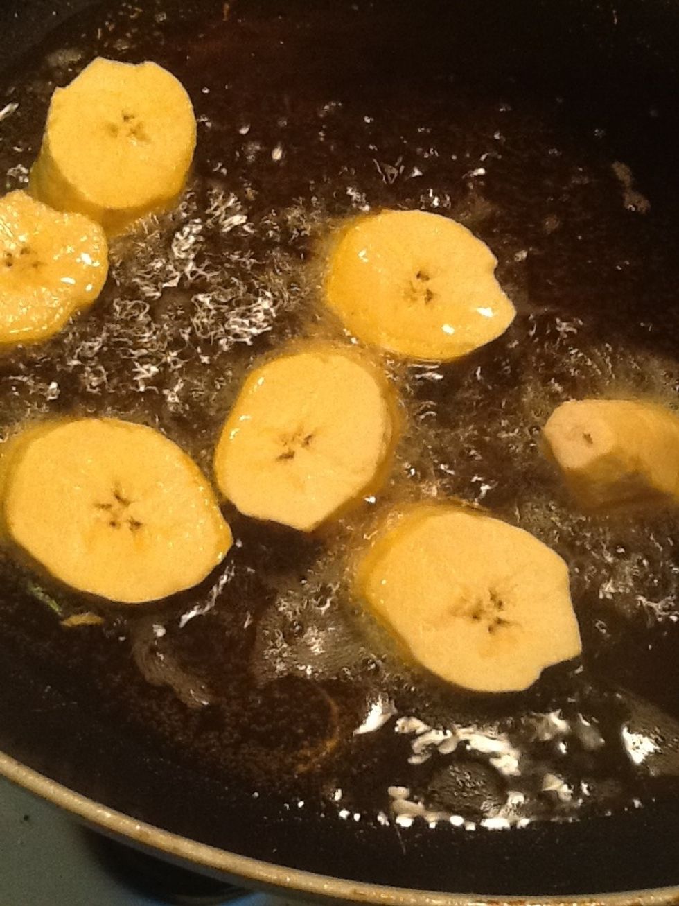 Take a pan and place it over medium high heat, add oil and fry the chunks of plantains we will it cook until golden brown.