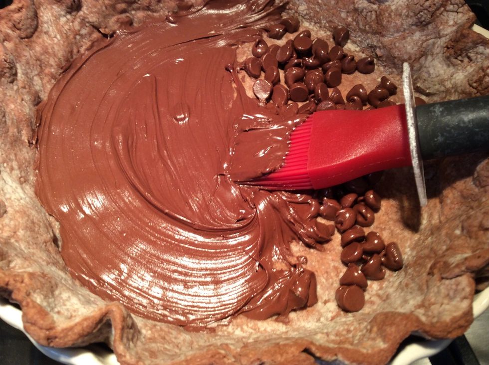 Take a pastry brush to paint the bottom and the side of the pie crust. This adds another level to this complex pie, but really, it helps prevent the crust from becoming soggy from the pastry cream.