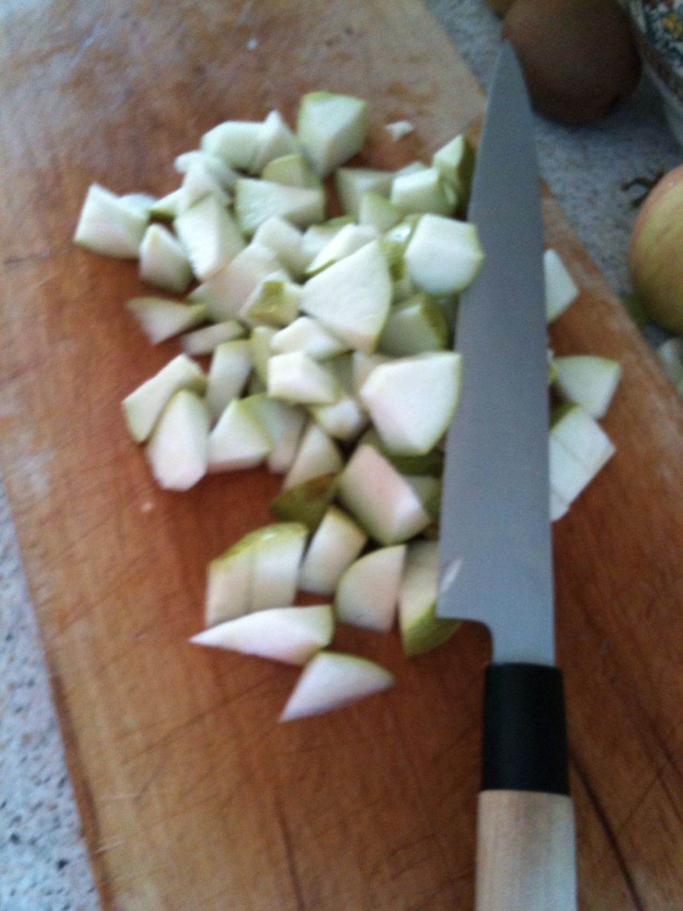 Take a pear and cut them in pieces, and put it in the bowl