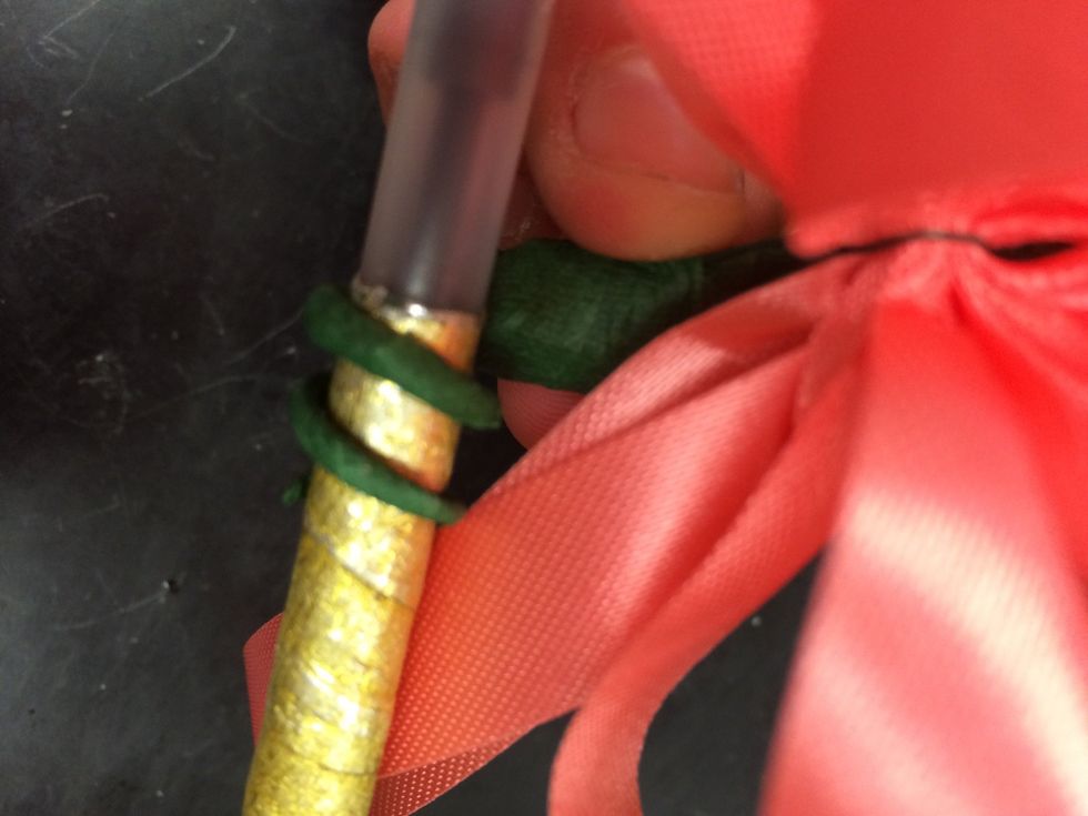 take a pen, pencil, extra stem, or anything that shape and wrap the end of wire around it so that you can make a curl at the end of the  corsage.