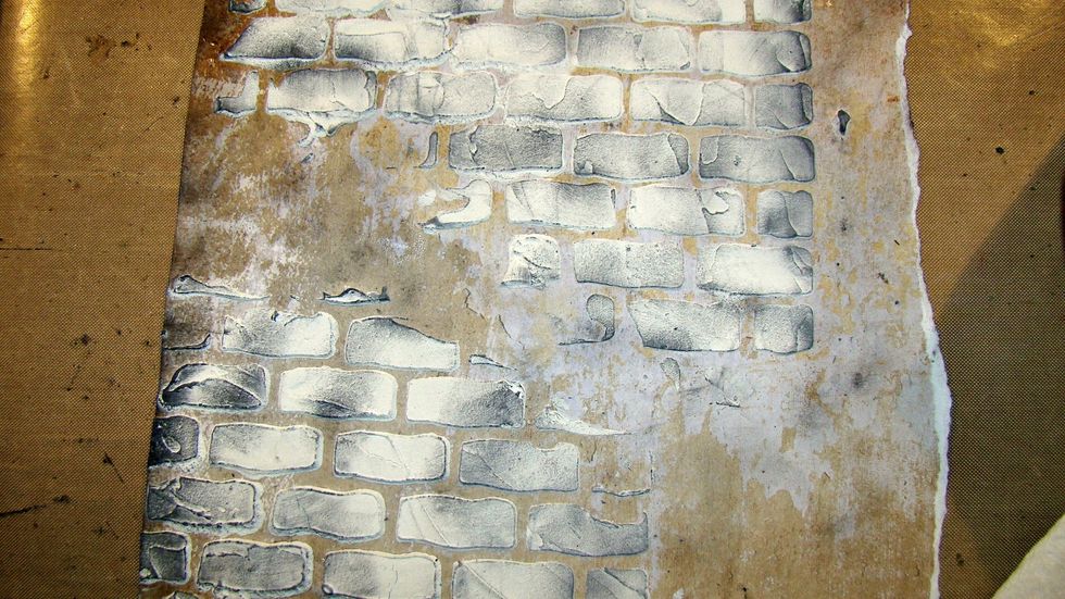 Take a piece of card stock and using a brick stencil and your AA Mud Texture Paste, stencil your background. Allow to dry.