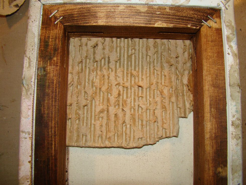 Take a piece of cardboard box and peel away at the corrugation on the cardboard. The grungier the better. Glue this is one corner of your shadow box.