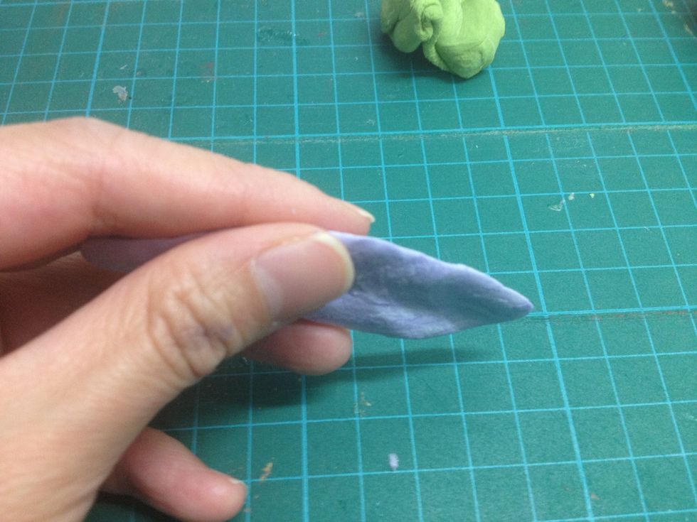 - Take a piece of clay and make it into sausage shape. Then, flatten it by fingers.