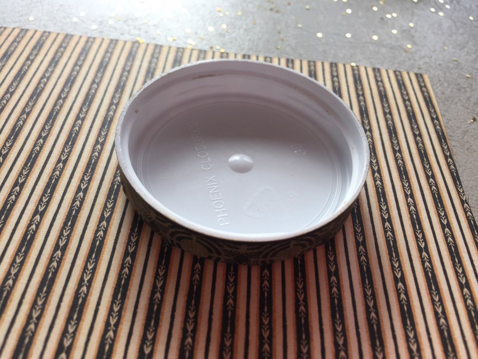Take a piece of Enchantment paper and place stripe side up. Place your lid on the paper and trace the circle shape.