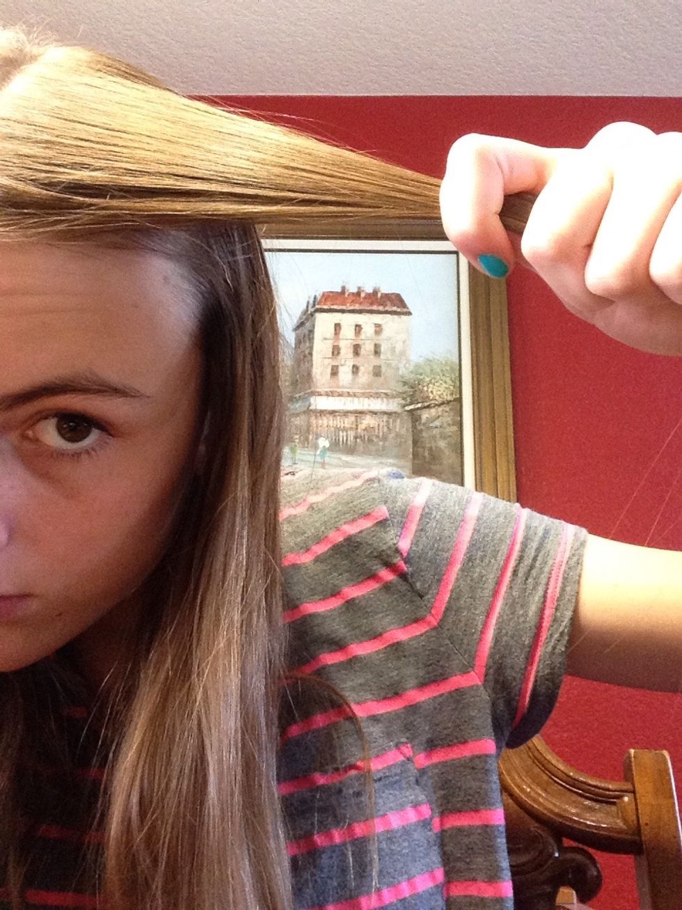 Take a piece of hair from one side of your part.