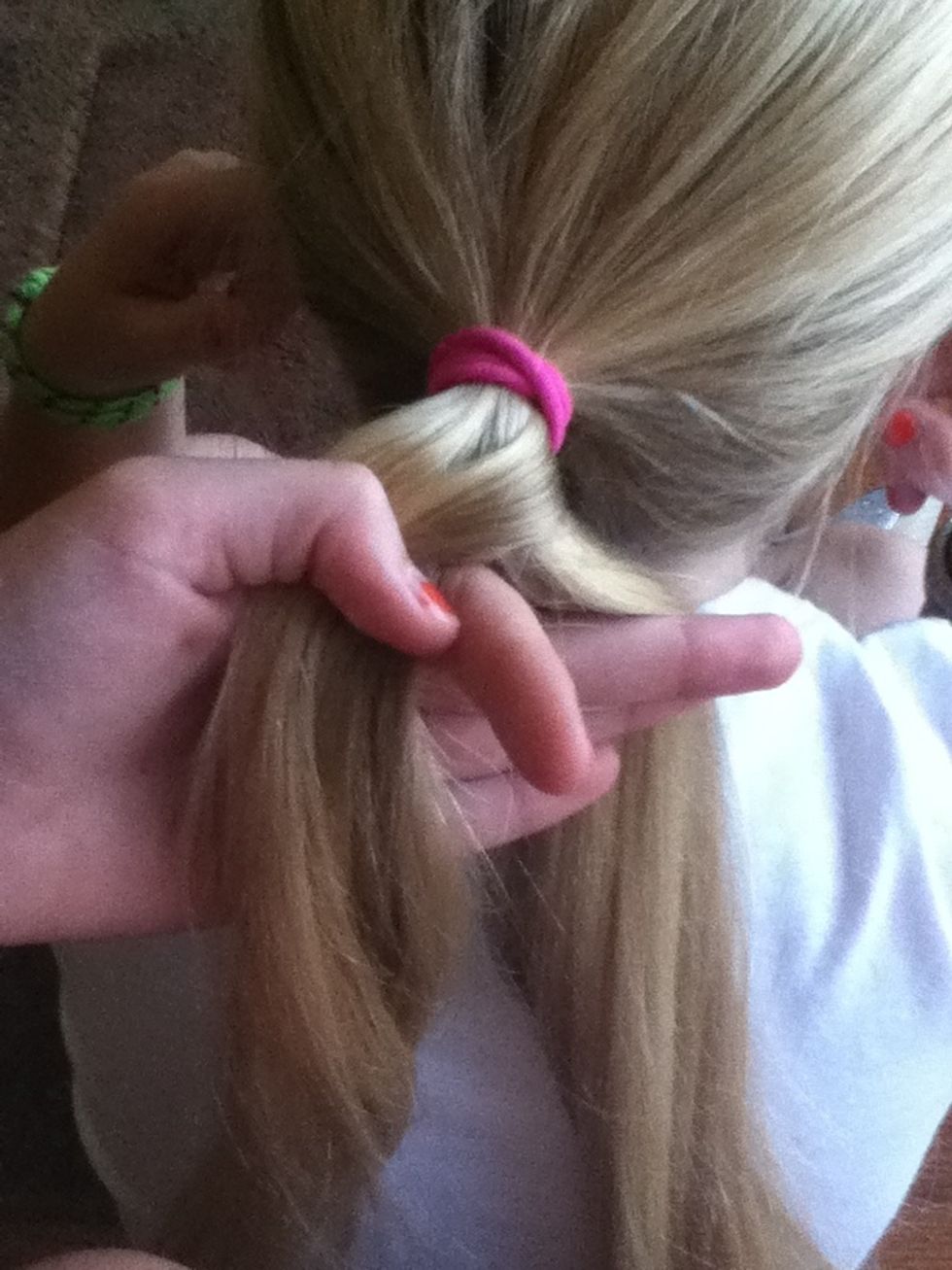 Take a piece of hair from the right strand and cross it over to the left strand.