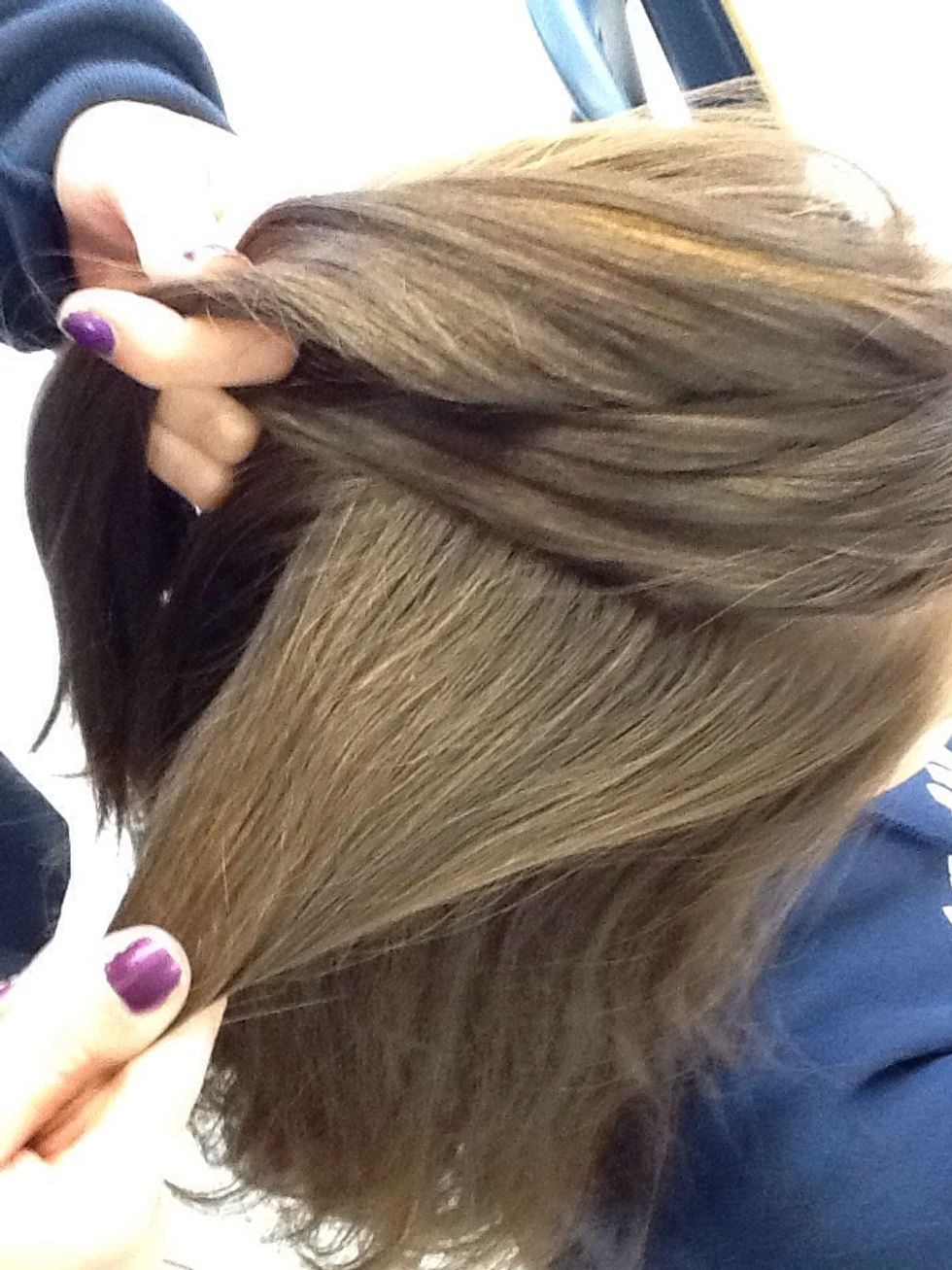 Take a piece of hair your not holding and cross it into the middle strand going in a backward French Braid movement