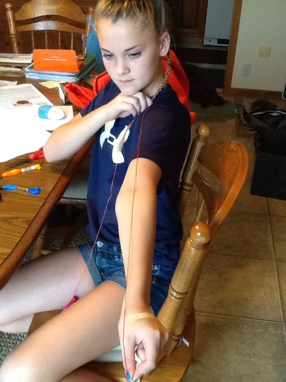 Take a piece of string arm length long and cut the string