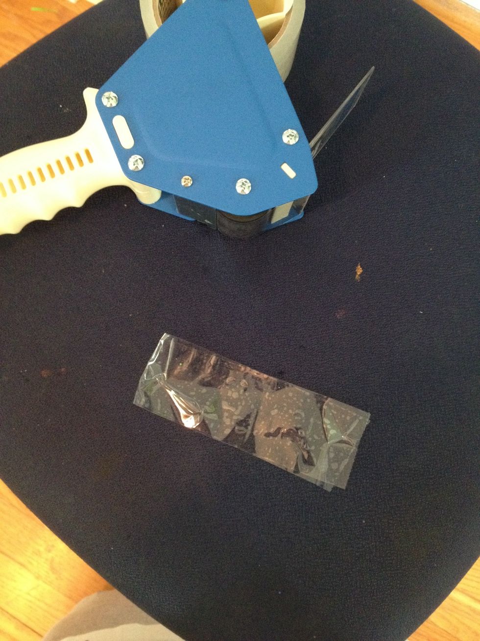 Take a piece of tape and fold it over itself. Repeat this over and over again, layering over the first one.